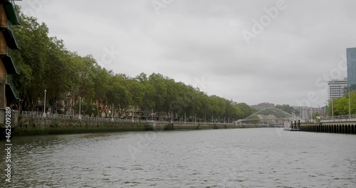 Crossing-boat cruise across the Bilbao river: bridges, urban life, river and buildings of the capital of the Basque Country seen from a boat.