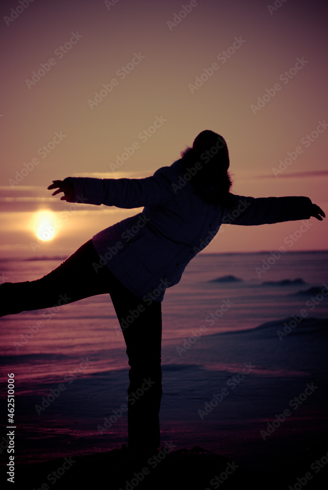 silhouette of a woman doing yoga