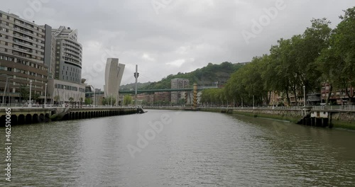 Crossing-boat cruise across the Bilbao river: bridges, urban life, river and buildings of the capital of the Basque Country seen from a boat.