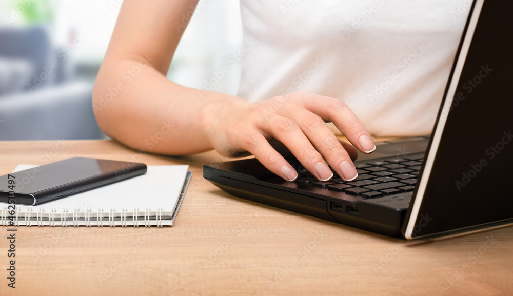 woman working on laptop sitting at the table, close-up woman working on laptop sitting at the table, close-up