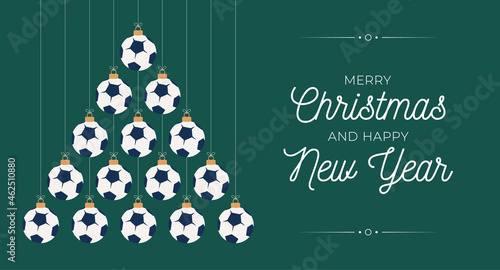 soccer Christmas and new year greeting card bauble tree. Creative Xmas tree made by football ball on black background for Christmas and New Year celebration. Sport greeting card