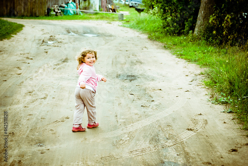 little girl walking on the road