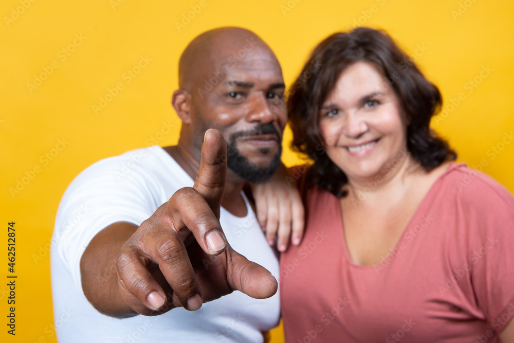 multiracial couple managing technology together multiracial couple managing technology together