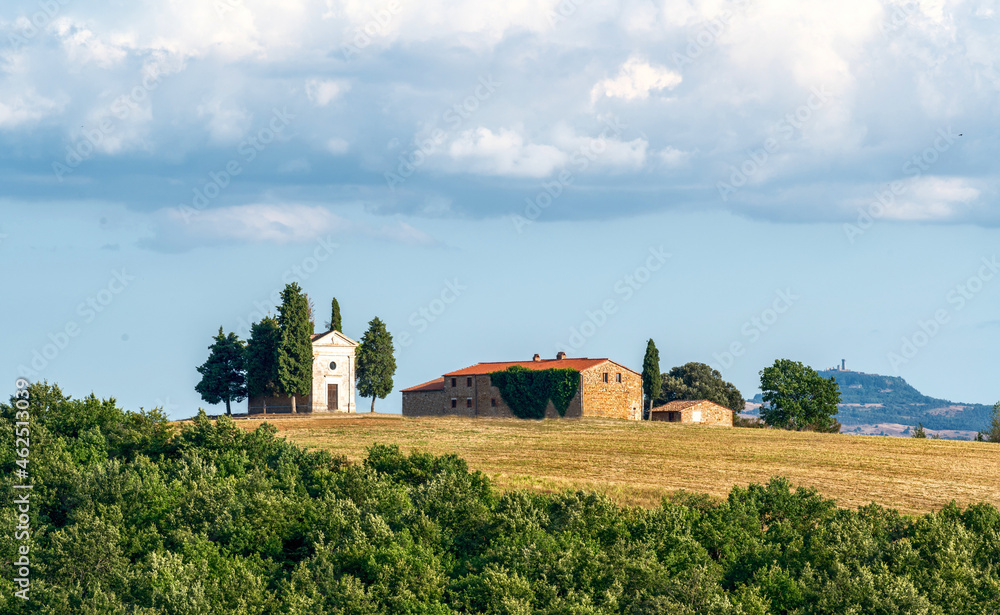 San Quirico d'Orcia, Tuscany, Italy. August 2020. The fascinating Chapel of the Madonna di Vitaleta on a beautiful sunny day. Blue sky with white clouds. Nobody.