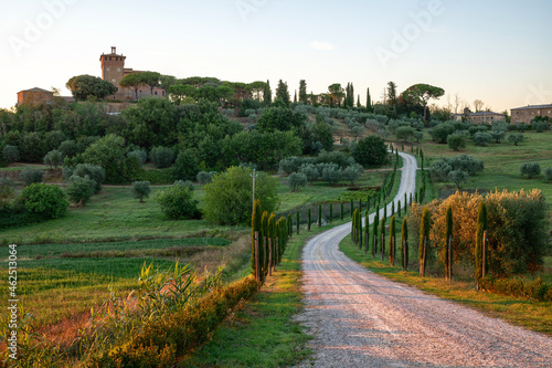 Tuscany, Italy. August 2020. Amazing landscape of the Tuscan countryside with the typical rolling hills and cypresses to mark the boundaries. In evidence the farm.