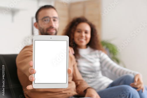 Couple with tablet computer at home