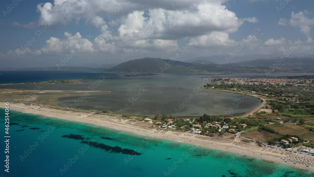 Aerial drone video of famous for water sports like kitesurfing sandy turquoise beach of Agios Ioannis with old abandoned windmills and lovely clouds, Lefkada island, Ionian, Greece Aerial drone video of famous for water sports like kitesurfing sandy turquoise beach of Agios Ioannis with old abandoned windmills and lovely clouds, Lefkada island, Ionian, Greece