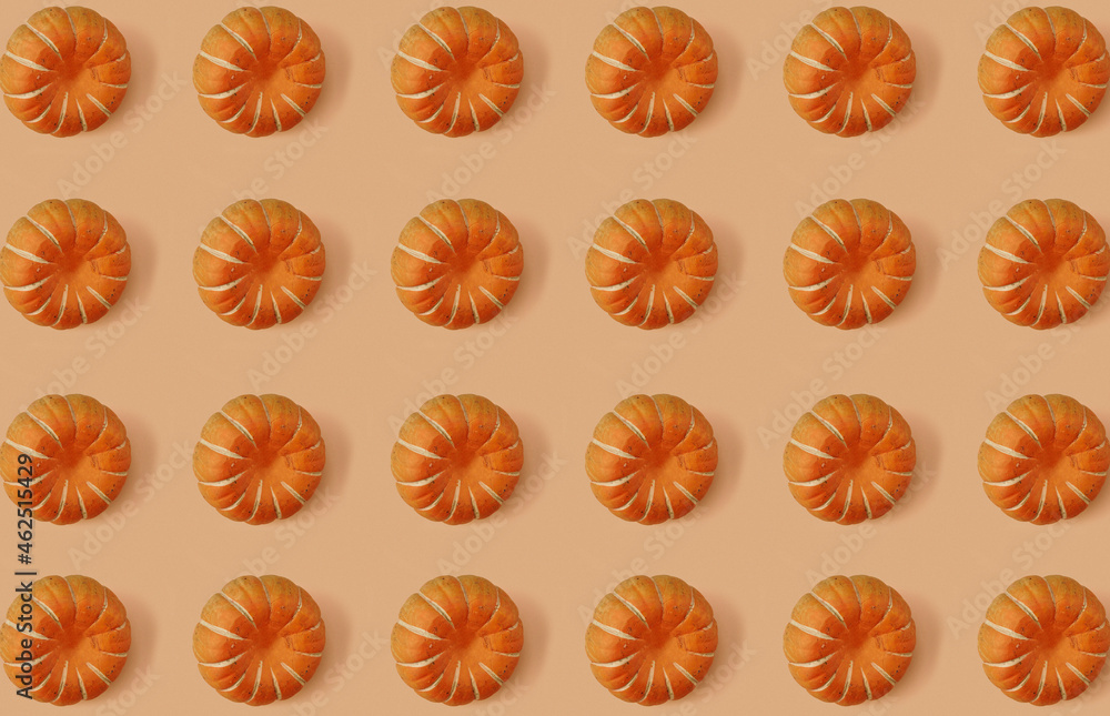 Fototapeta premium Pattern of pumpkins on orange pastel background