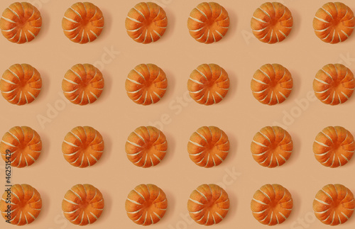 Pattern of pumpkins on orange pastel background