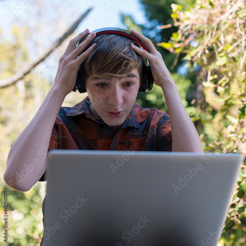 Joven preocupado por las tareas en clase virtual.  photo