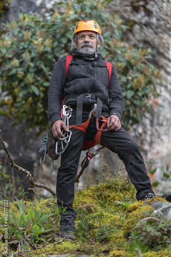 Old man climber on the mountain