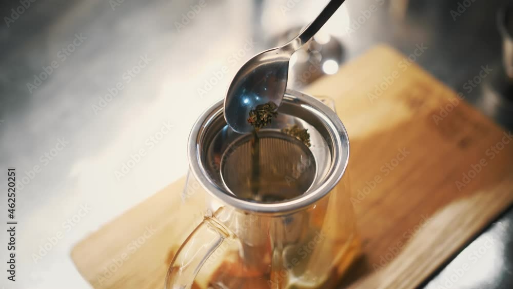 tea drink. preparation of tea. close-up. top view. a spoonful of dry, flower, leafy green tea is poured into the teapot. fruity berry hot drink tea drink. preparation of tea. close-up. top view. a spoonful of dry, flower, leafy green tea is poured into the teapot. fruity berry hot drink