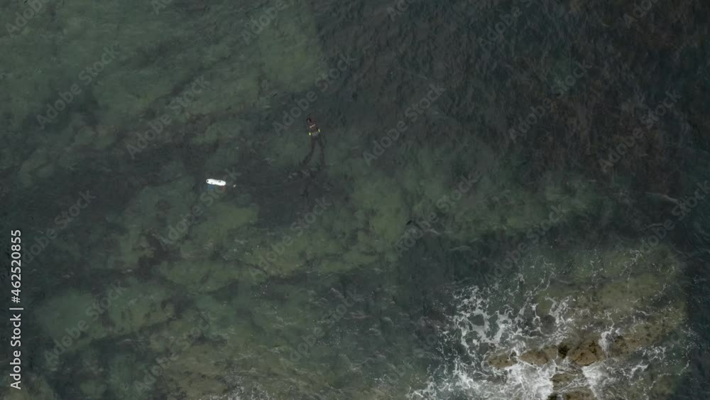 Aerial view of a person doing Scuba diving along the wild coastline near Zennor Cove, Saint Ives, Cornwall, United Kingdom. Aerial view of a person doing Scuba diving along the wild coastline near Zennor Cove, Saint Ives, Cornwall, United Kingdom.