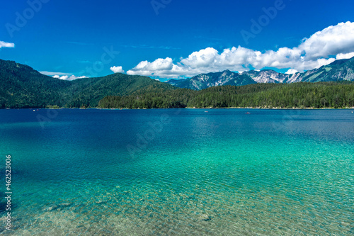 Faboulus landscape of Eibsee Lake with turquoise water in front of Zugspitze summit under sunlight. Location: Eibsee lake, Garmisch-Partenkirchen Bavarian alps, Germany, Europe