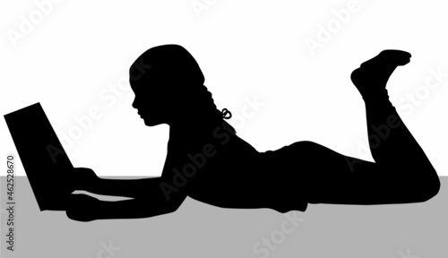 Silhouette of a girl reading a book.