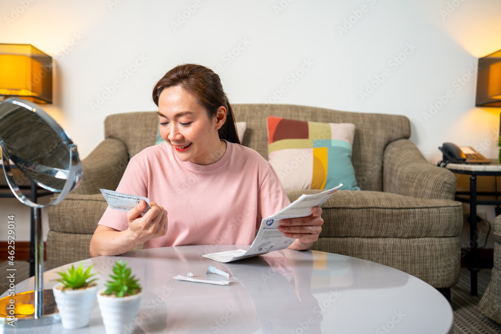 4K Asian woman using rapid antigen test kit for self test COVID-19 epidemic at home. Adult female unpacking a swab for inserts into her nose. COVID-19 coronavirus pandemic protection concept. 4K Asian woman using rapid antigen test kit for self test COVID-19 epidemic at home. Adult female unpacking a swab for inserts into her nose. COVID-19 coronavirus pandemic protection concept.