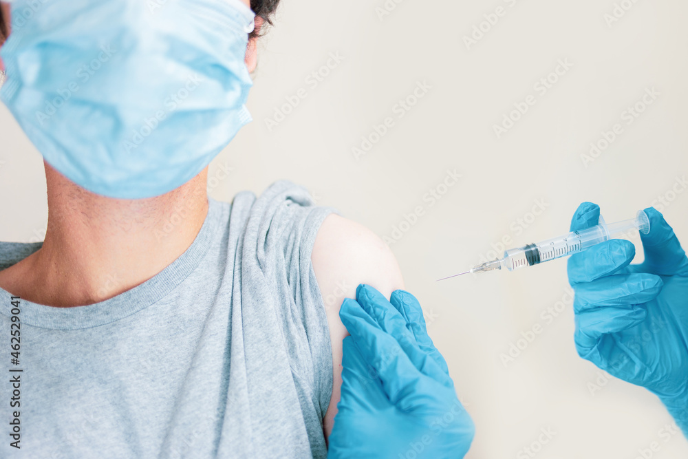 Young man receiving the coronavirus vaccine. Concept of immunization campaign against coronavirus. Young man receiving the coronavirus vaccine. Concept of immunization campaign against coronavirus.