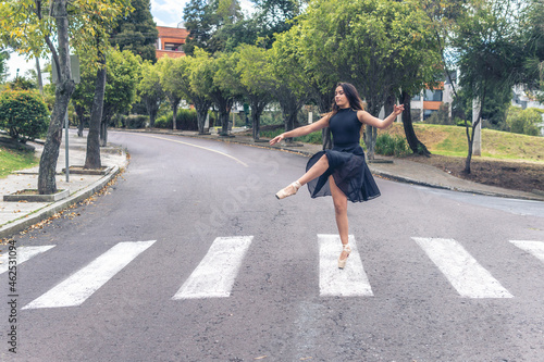 Elegant ballet figure of a ballerina crossing a pedestrian crossing on the street