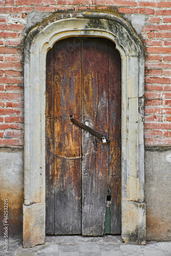 wooden door with a rusted antique brick facade