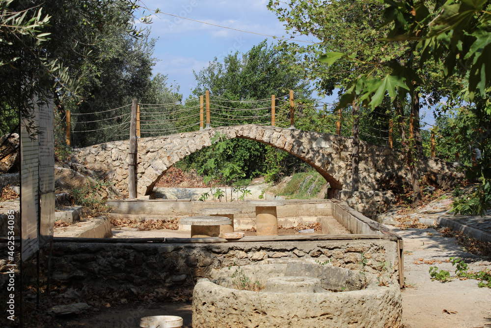 a stone bridge and an ancient well in a hot southern country