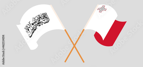 Crossed and waving flags of Taliban and Malta