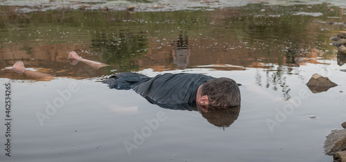 the body of a man who drowned, lying face down in the water lifeless body
