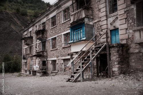 Wallpaper Mural Abandoned building in ruined by mudflow old town high in mountains with intricate stonework, ruined balconies, crashed windows. Desolation and destruction Torontodigital.ca