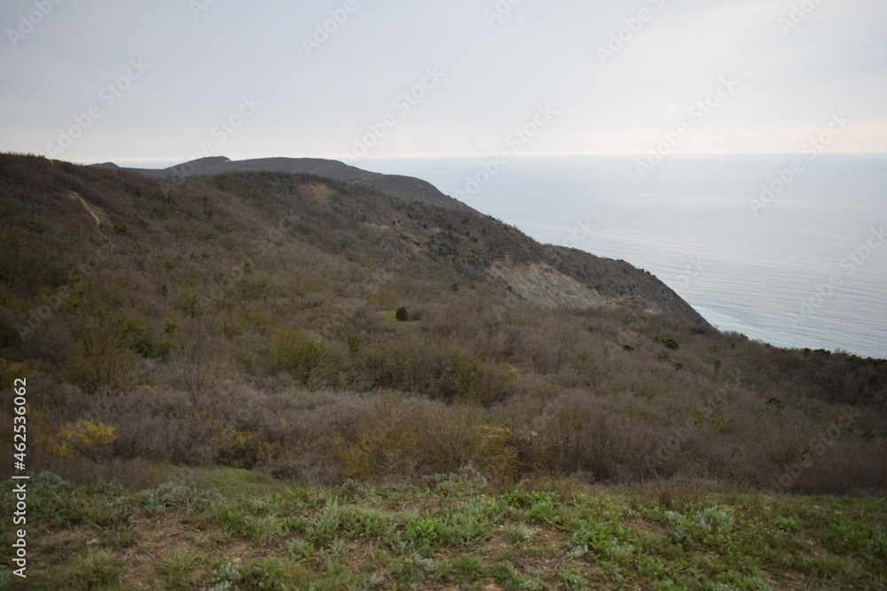 The outskirts of Anapa. Mountains and rocks, sunset. Black Sea on the horizon. Photo taken in spring.	