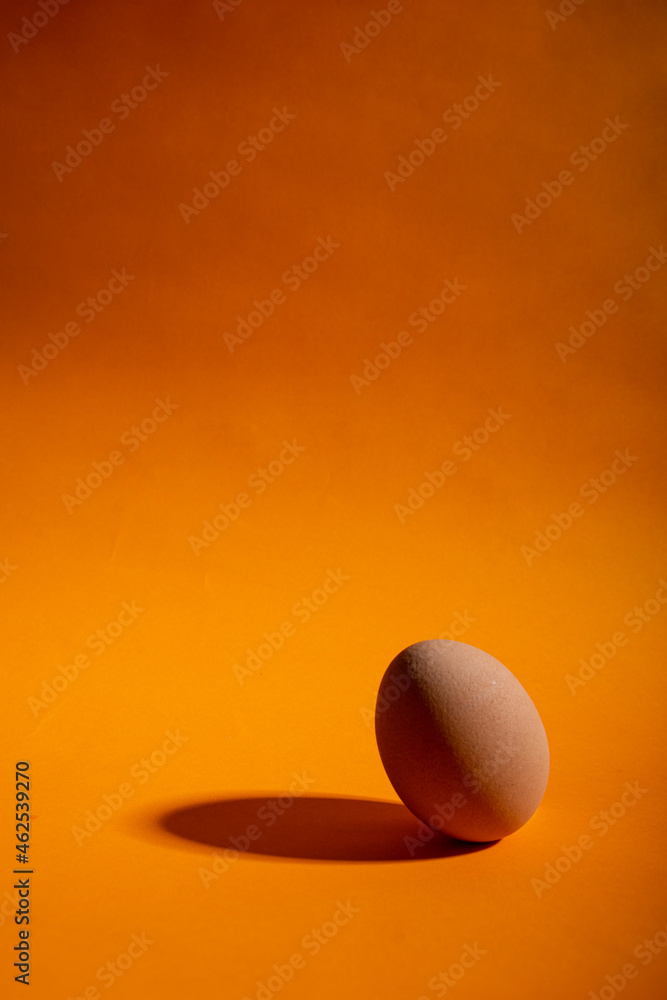 whole eggs on healthy orange background whole eggs on healthy orange background