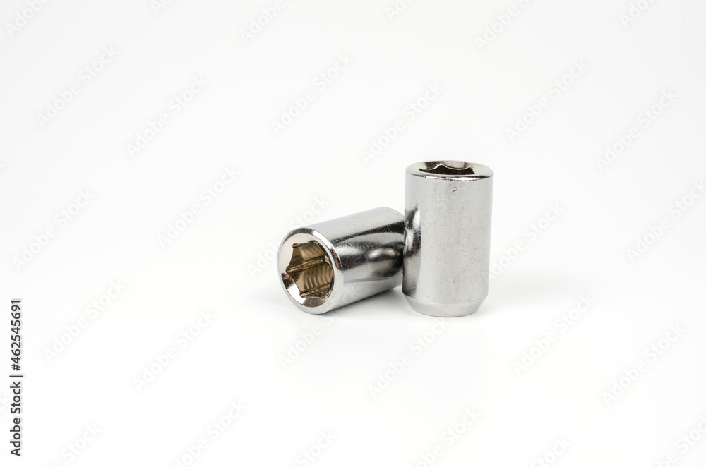 metal nut fastening the car wheel close-up on a white background. car spare part metal nut fastening the car wheel close-up on a white background. car spare part