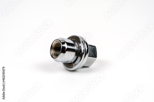 metal nut fastening the car wheel close-up on a white background. car spare part