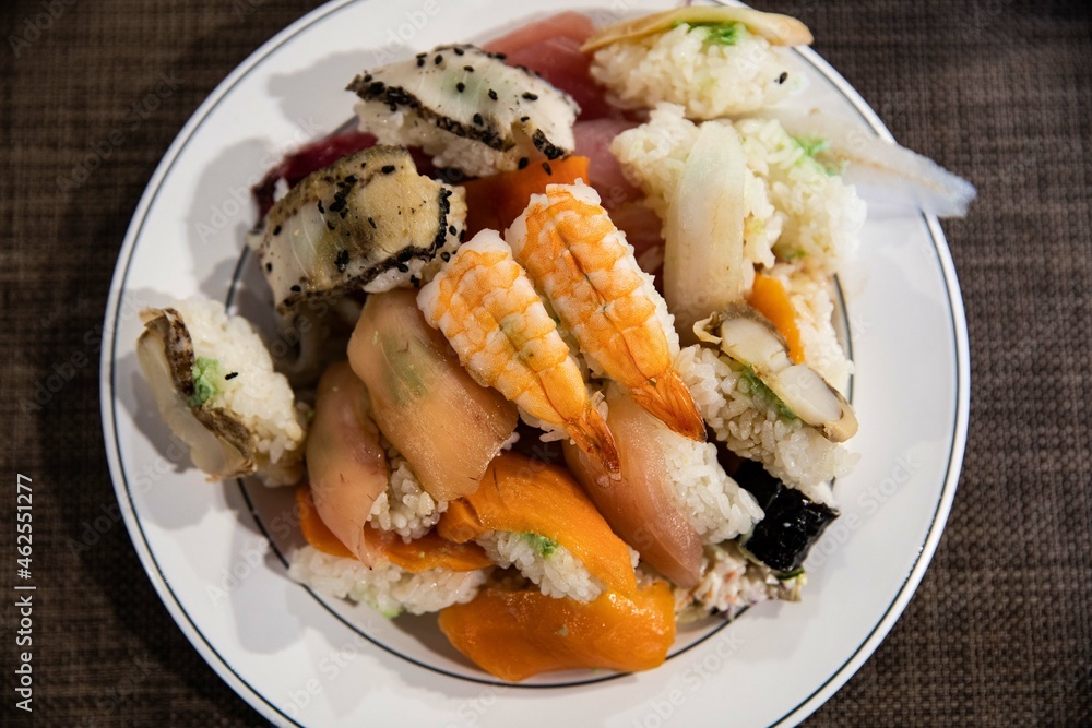 A plate of various kinds of fish sushi at a buffet restaurant, Japanese food A plate of various kinds of fish sushi at a buffet restaurant, Japanese food