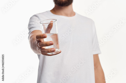 bearded man glass of water light background