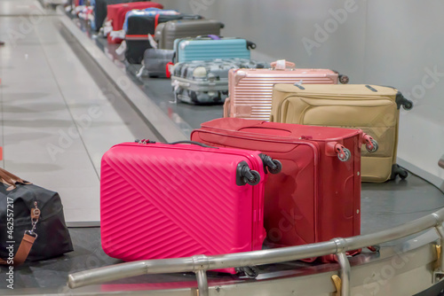 Suitcase or luggage with conveyor belt in the airport photo