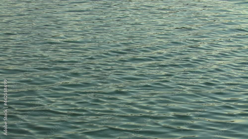 Infinite background of water waves in lake. Blue to black colors. Natural texture. Infinite background of water waves in lake. Blue to black colors. Natural texture.