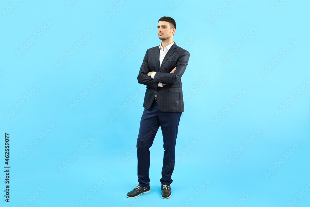 Young businessman in classic suit on blue background Young businessman in classic suit on blue background