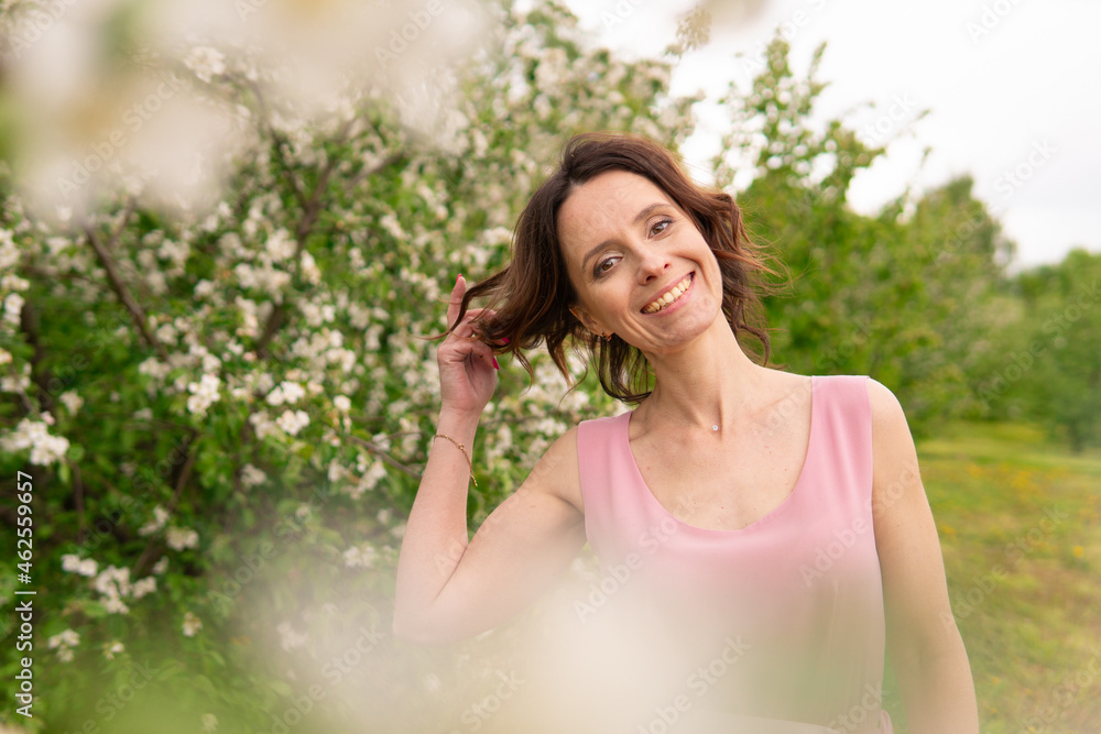 A woman near a blooming spring tree. Romantic happy mood. A woman near a blooming spring tree. Romantic happy mood.