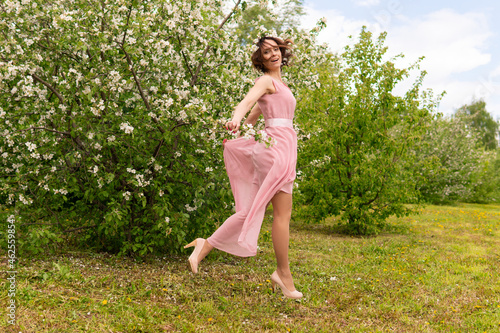 A woman near a blooming spring tree. Romantic happy mood.