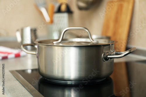 Concept of kitchen utensil with metal pot, selective focus