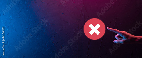 Hand holds icon,cancellation symbol,cancel icon.Cross mark flat red icon.round X mark.cancel button.Wrong.cross mark rejection.Declined.On dark background.Banner.Copy space.Place for text. photo