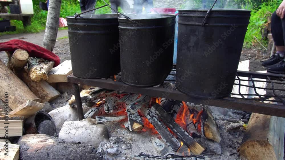 Bonfire with three cauldrons for cooking in the camp. Kindle Fire Bonfire with three cauldrons for cooking in the camp. Kindle Fire