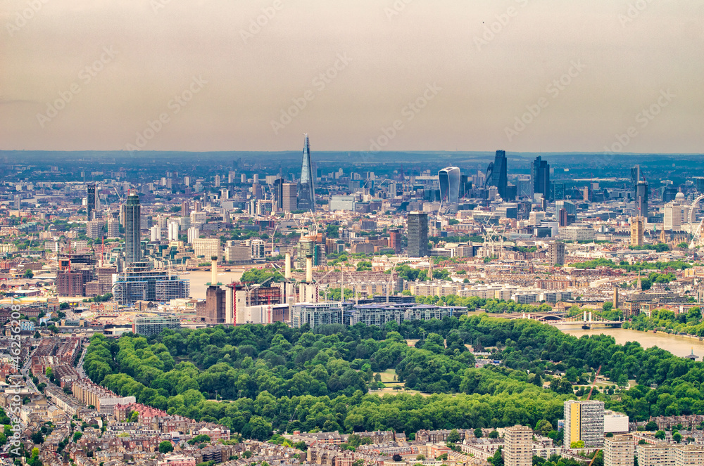 London aerial view from helicopter. City skyline and park on a summer day.