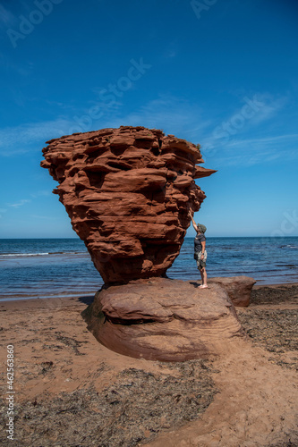 Woman standing on Sea Stack, Thunder cove beach, Prince Edward Island, Gulf of St Lawrence, Canada