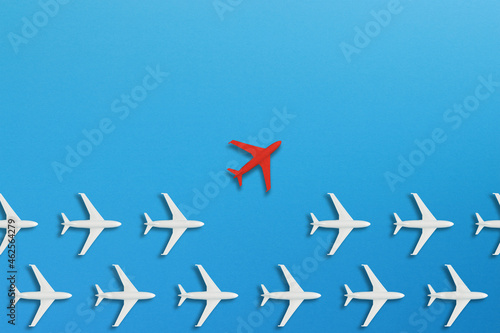 Red airplane coming out from the advancing white airplanes  different business concept