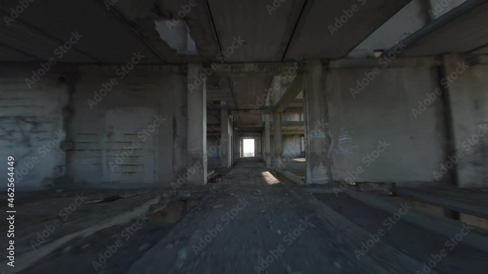 FPV drone flies fast through an abandoned building. Post-apocalyptic location without people