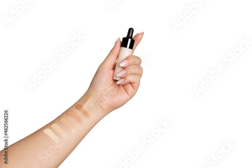 Female hand holding cream facial foundation