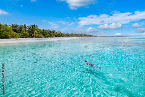 Caucasian couple snorkel in crystal turquoise water for underwater sea wildlife Maldives Island. Summer sport, recreational luxury resort beach shore coast ocean water, couple exotic traveling tourism © icemanphotos