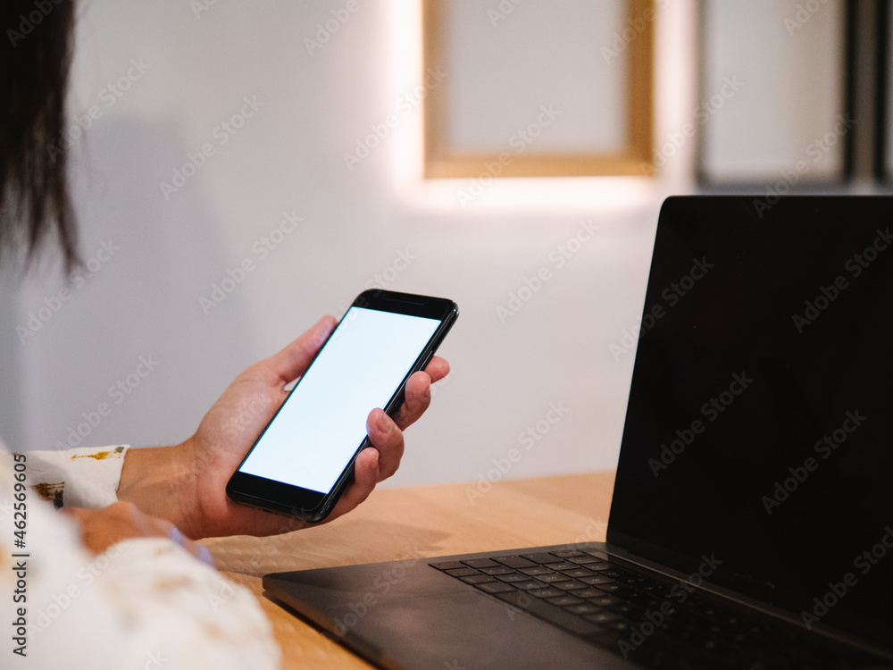 unrecognizable working woman's hand holding a phone while viewing it unrecognizable working woman's hand holding a phone while viewing it