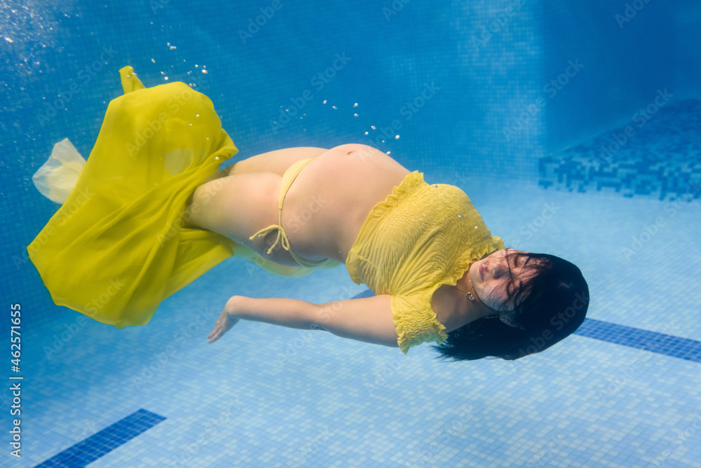 Pregnant woman swim, dive in swimming pool. Aqua fitness healthcare