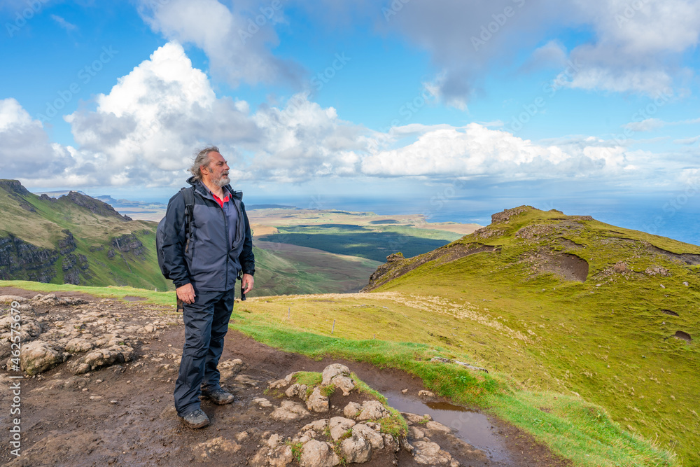 A male hiker admires views from The Old Man of Storr A male hiker admires views from The Old Man of Storr